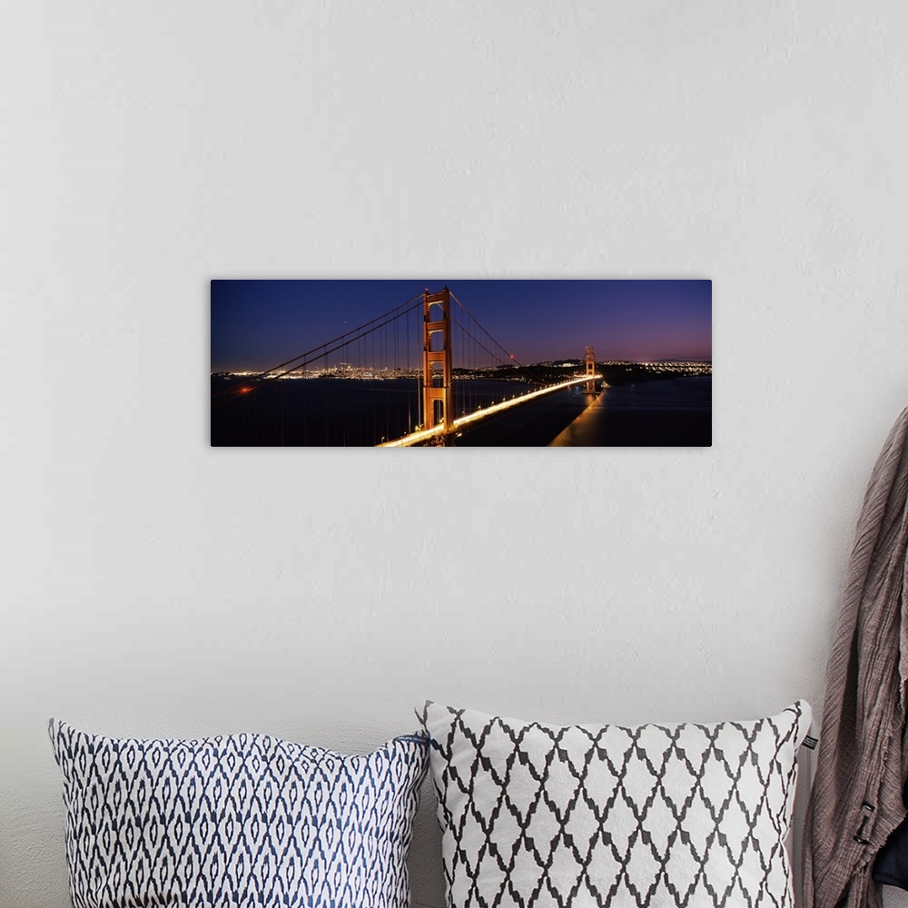 A bohemian room featuring Panoramic photograph of overpass at night with the city skyline in the distance.  The overpass is...