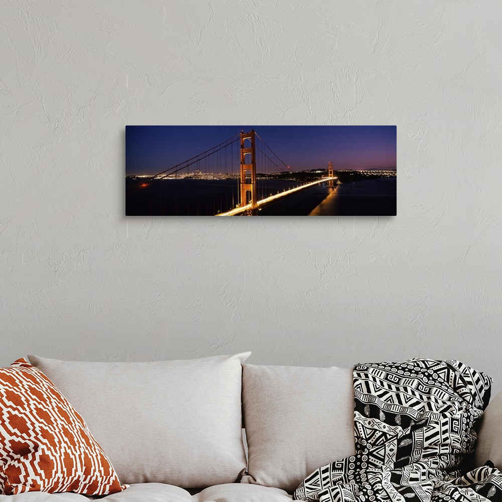 A bohemian room featuring Panoramic photograph of overpass at night with the city skyline in the distance.  The overpass is...