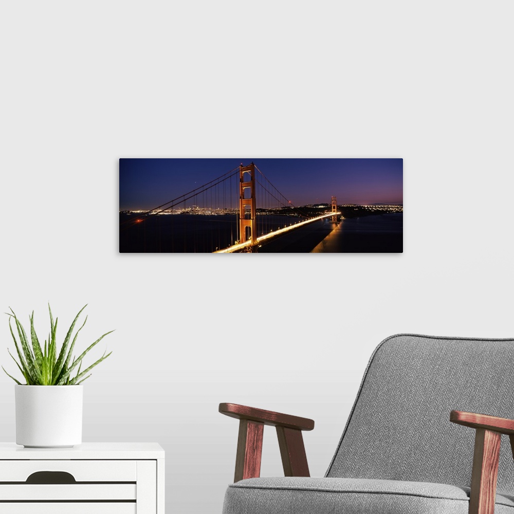 A modern room featuring Panoramic photograph of overpass at night with the city skyline in the distance.  The overpass is...