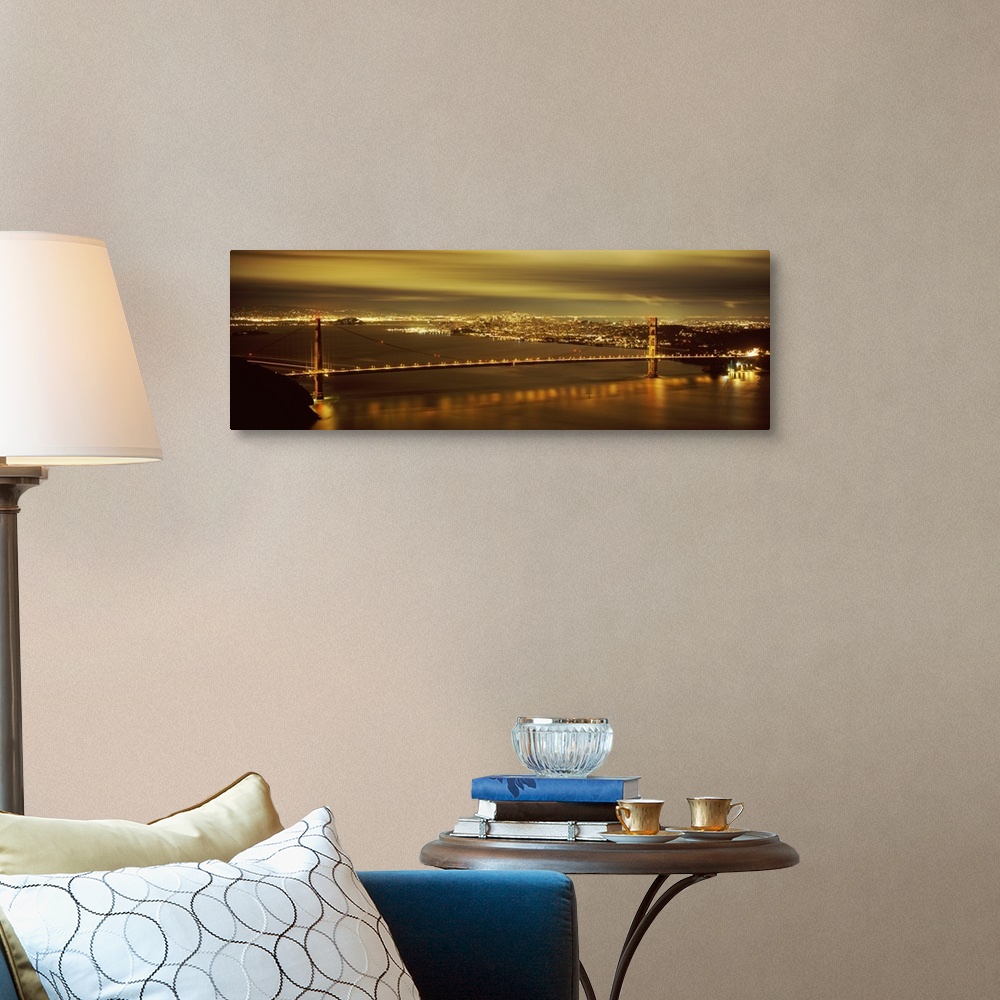 A traditional room featuring Giant, wide angle photograph of the Golden Gate Bridge lit up at night, the city lights of San Fr...