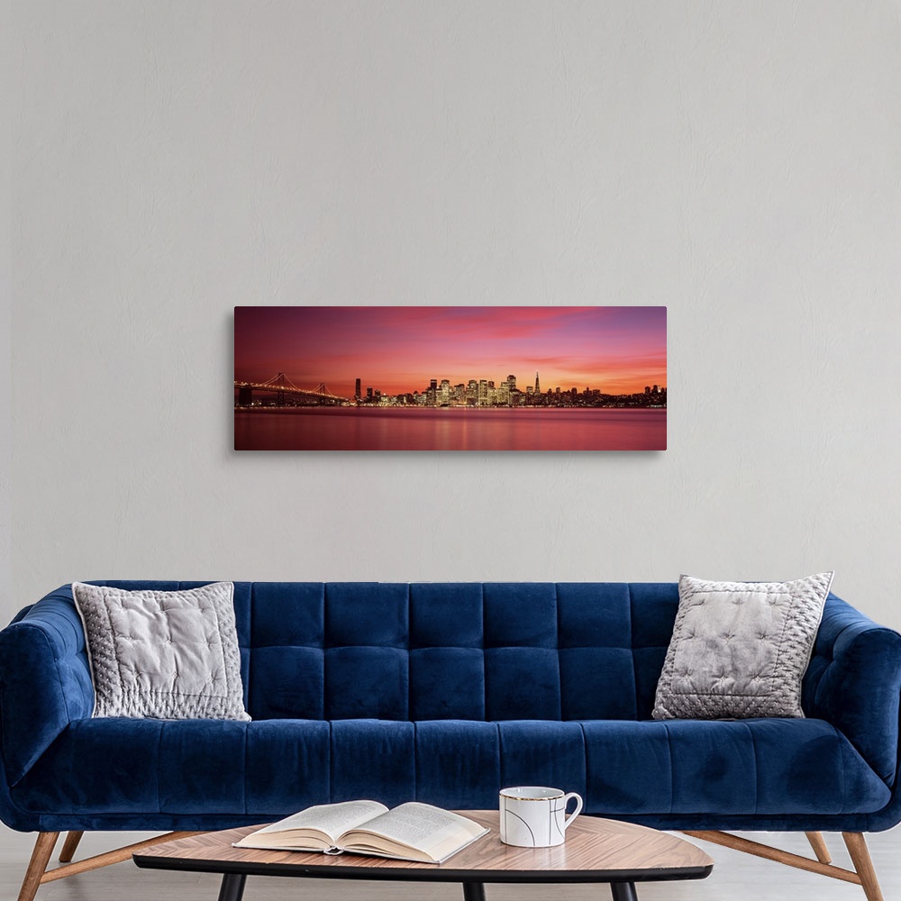 A modern room featuring Cityscape in the evening with lights on the skyscrapers as the sunlight fades away with wispy pin...