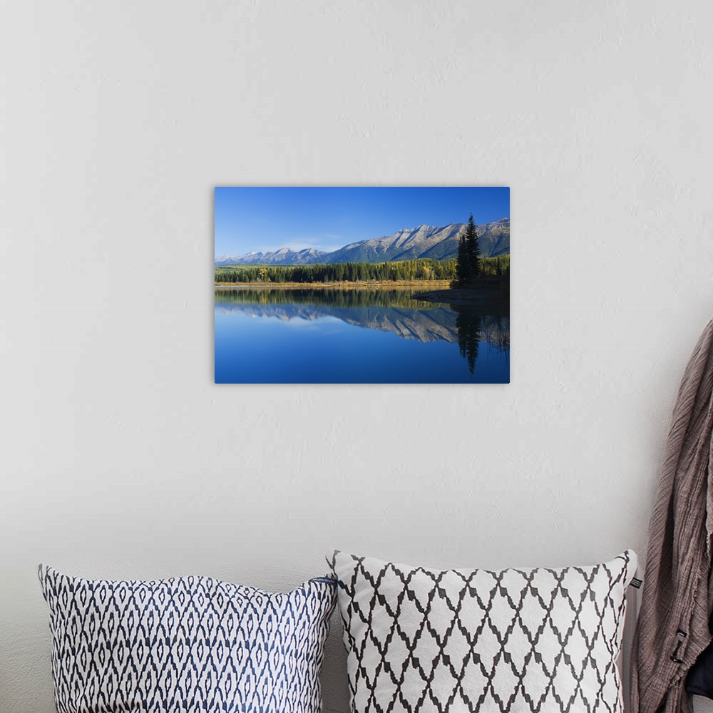 A bohemian room featuring Big canvas photo of mountains and their reflection onto the lake in front of them.