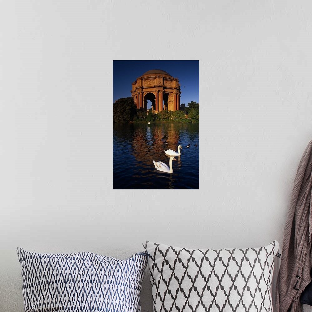 A bohemian room featuring Tall canvas print of two swans swimming in a lake in front of a big monument.