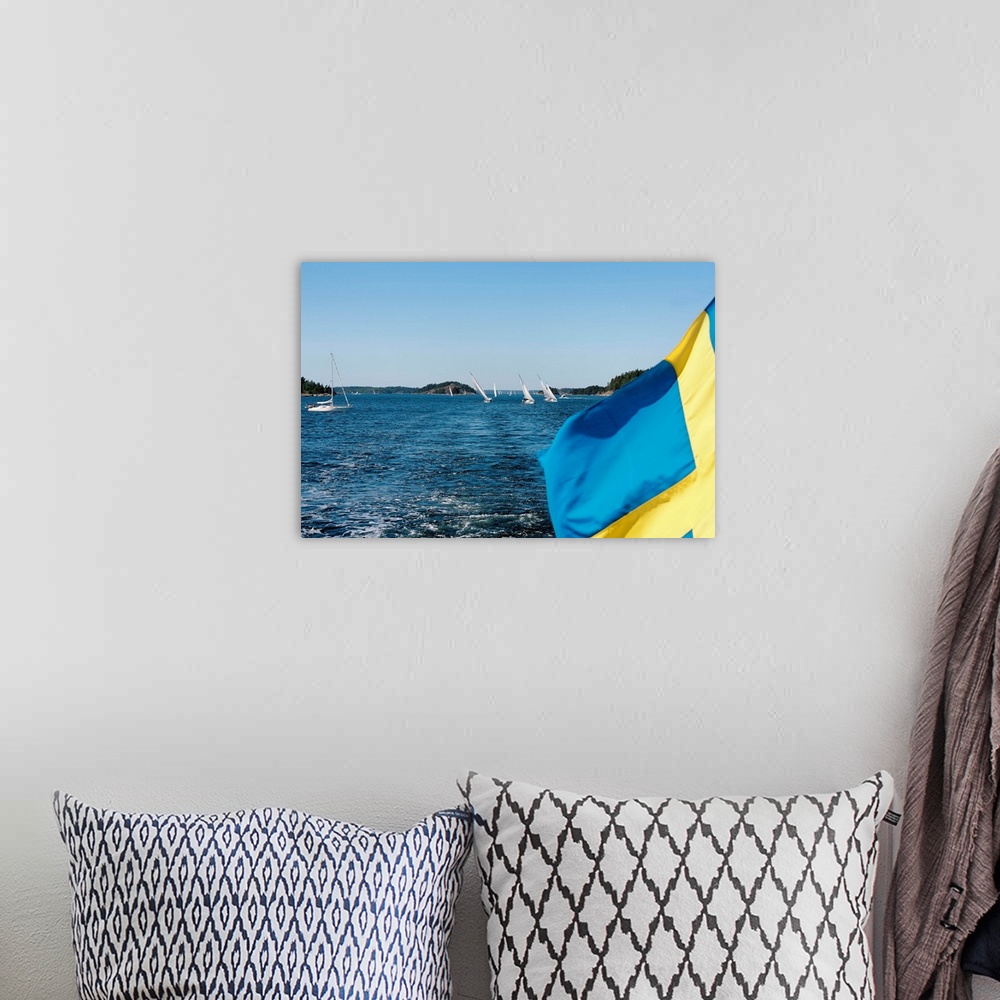 A bohemian room featuring Close-up of a Swedish flag with sailboats in the background, Stockholm Archipelago, Stockholm, Sw...