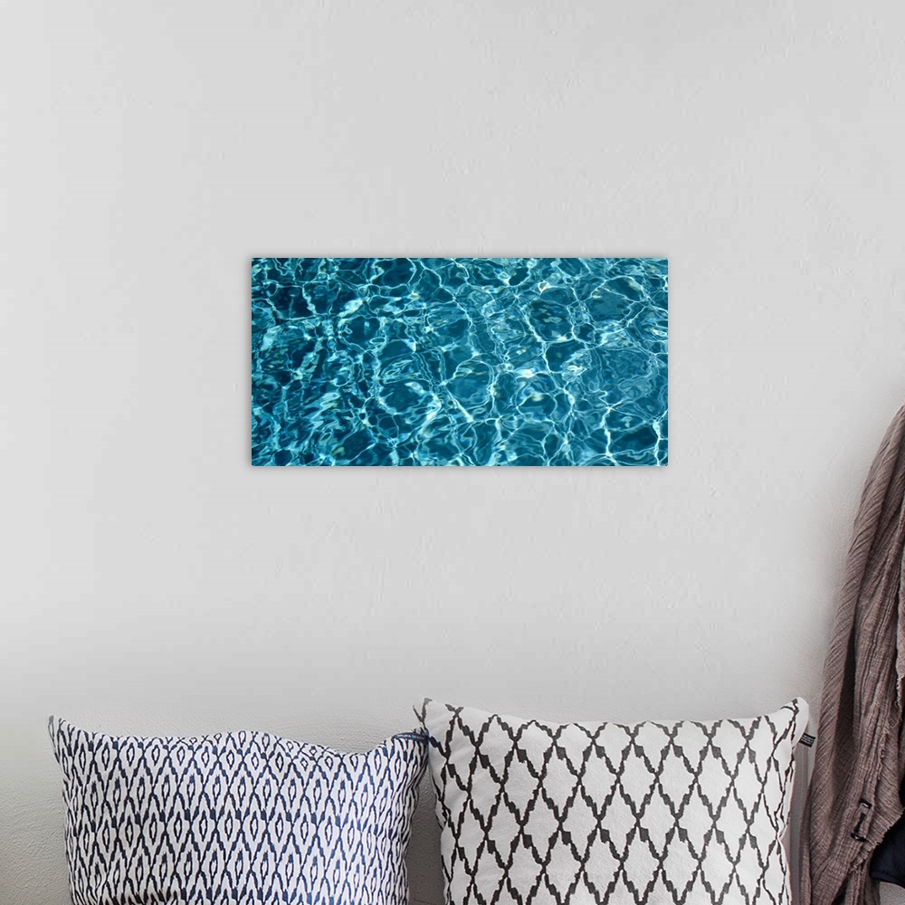 A bohemian room featuring Panoramic photograph of water reflected in the bottom of a pool.