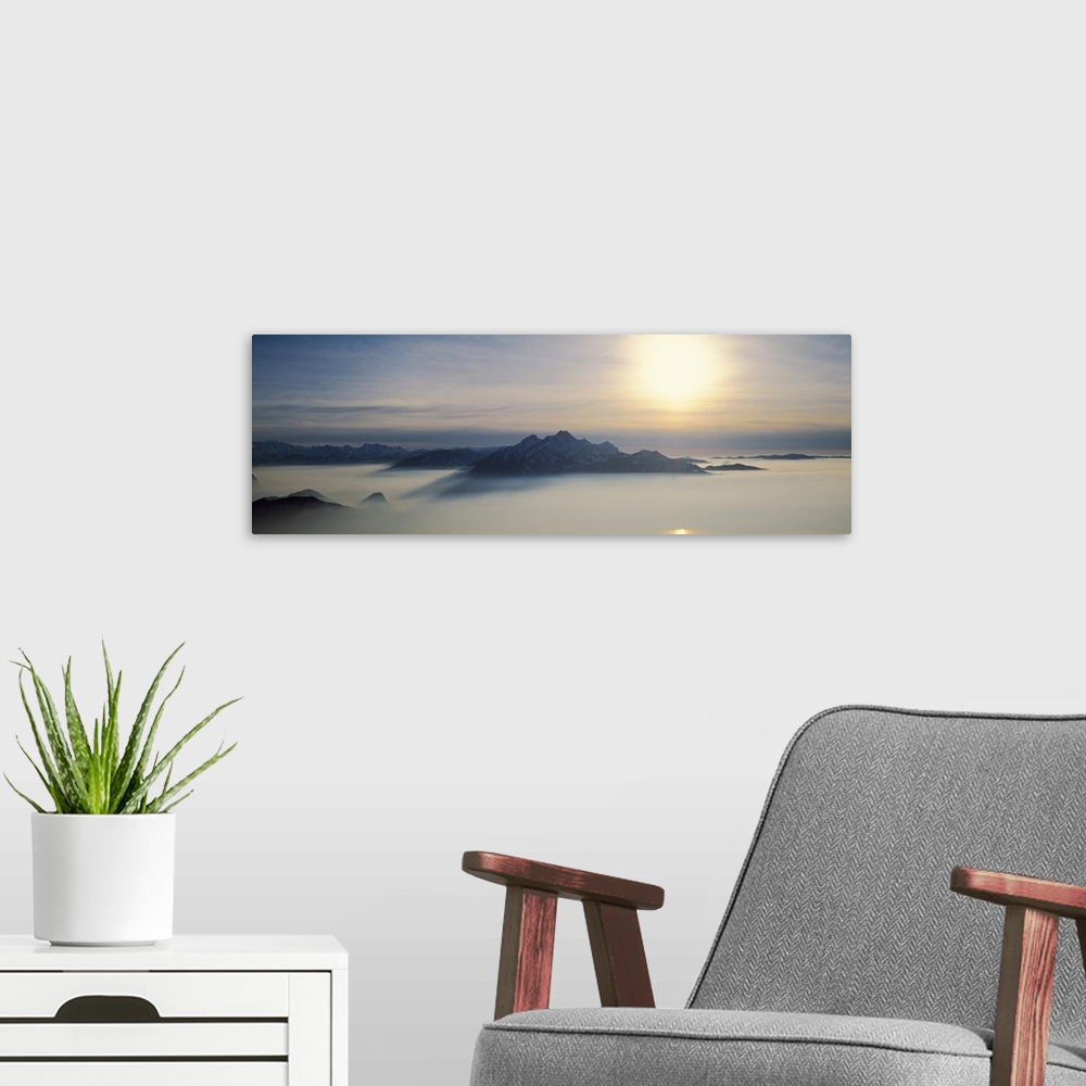 A modern room featuring Switzerland, Luzern, Pilatus Mountain, Panoramic view of mist around a mountain peak