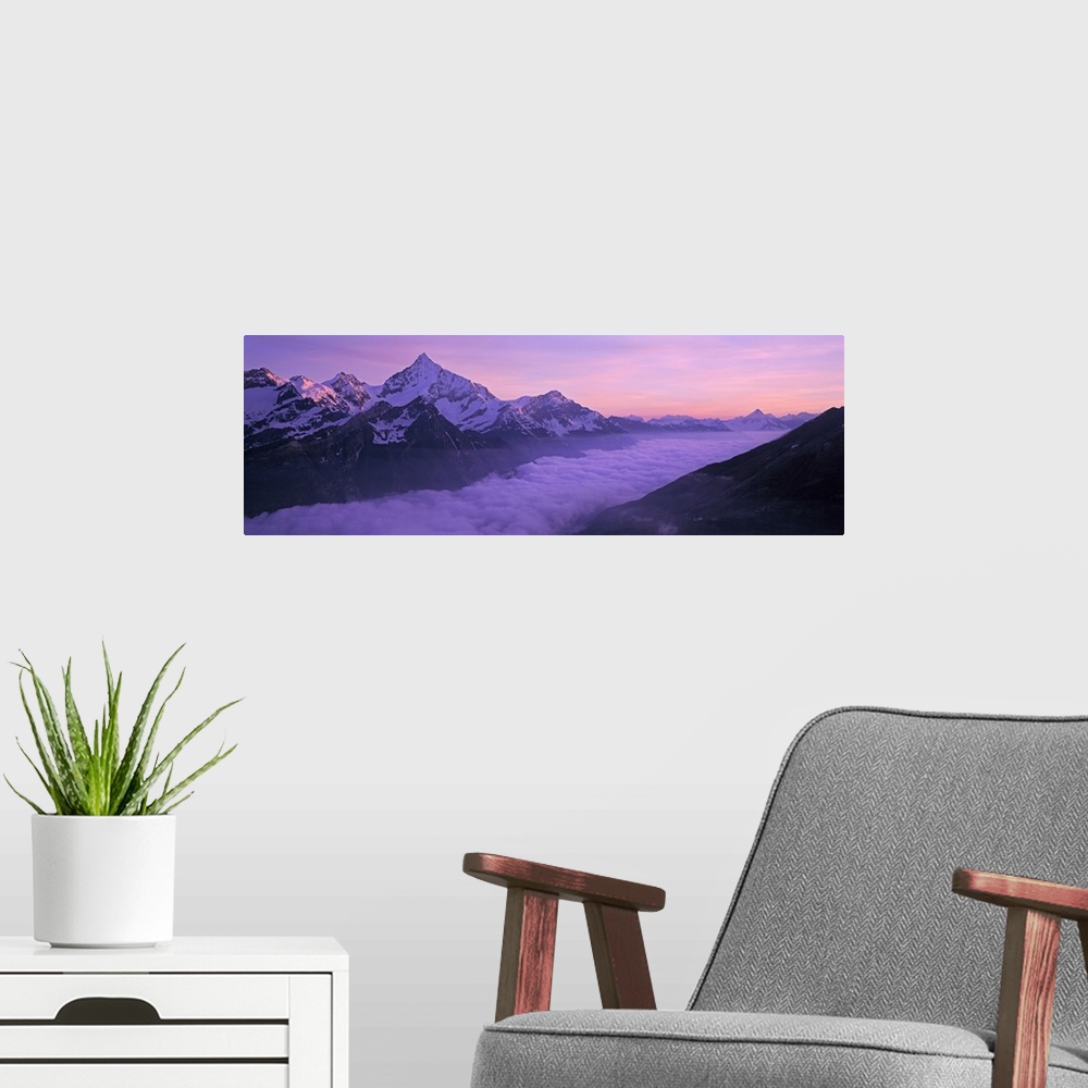 A modern room featuring Switzerland, Swiss Alps, Aerial view of clouds over mountains