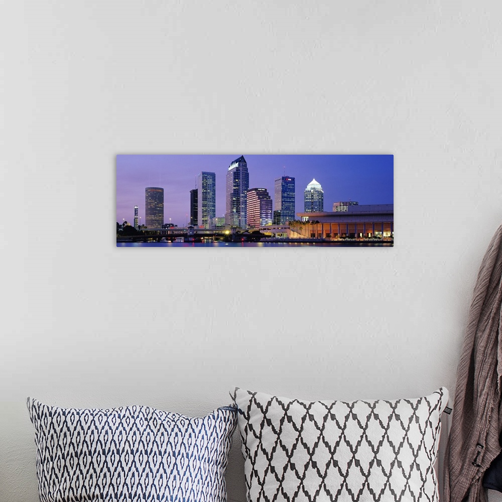 A bohemian room featuring Wide angle photograph of the Tampa skyline in front a vivid sky, lit up at night and reflecting i...