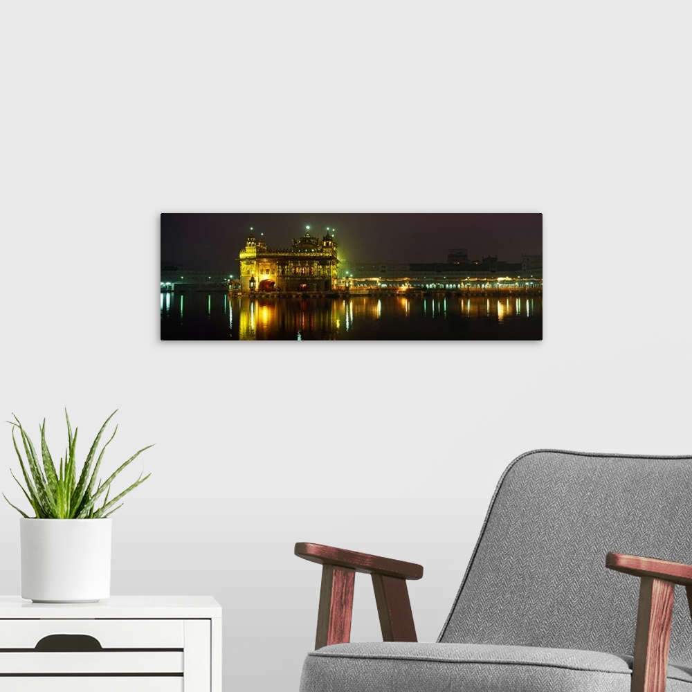 A modern room featuring Temple lit up at night, Golden Temple, Amritsar, Punjab, India