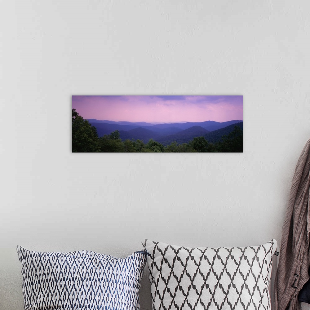 A bohemian room featuring Wide angle photograph taken of the smoky mountains with some trees lining the bottom of the picture.