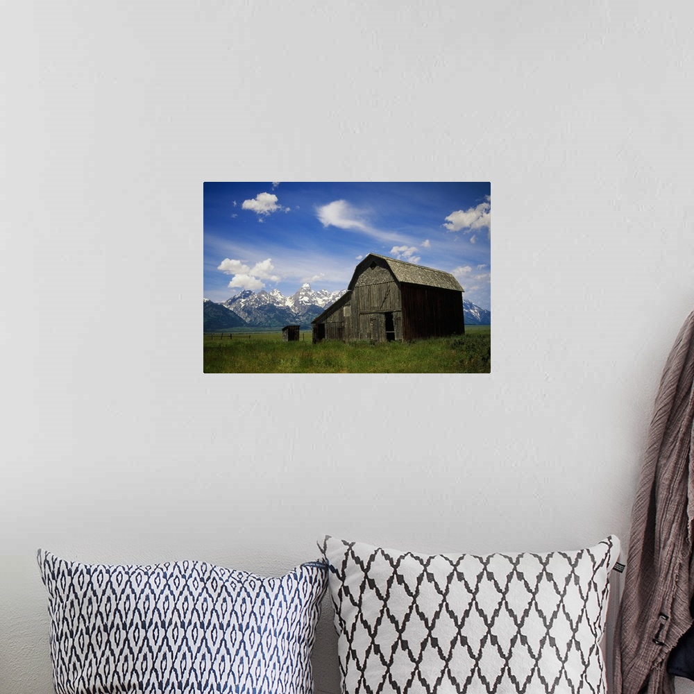 A bohemian room featuring Large photograph of a rustic barn in a grassy field with a mountain range behind it in Grand Teto...