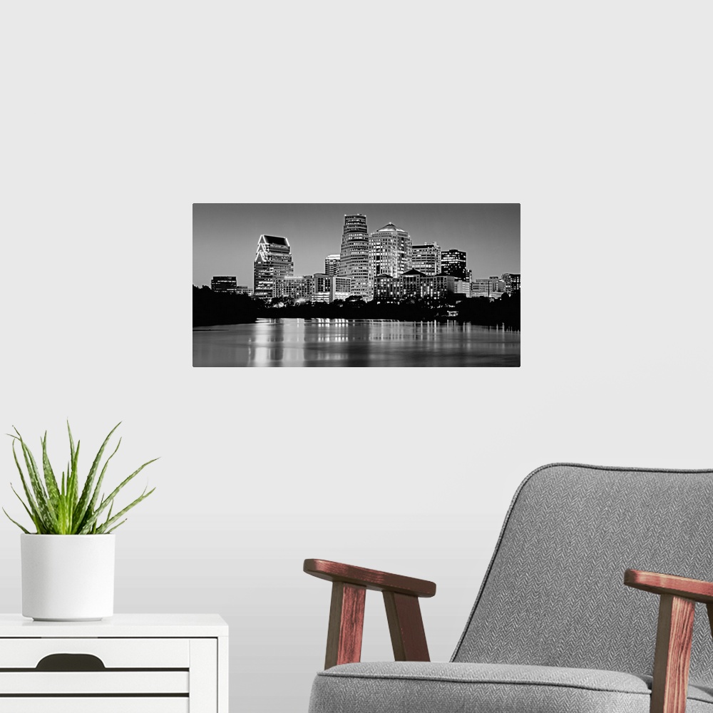 A modern room featuring Panoramic monochromatic photograph showcases the busy skyline of a famous city within the Southwe...