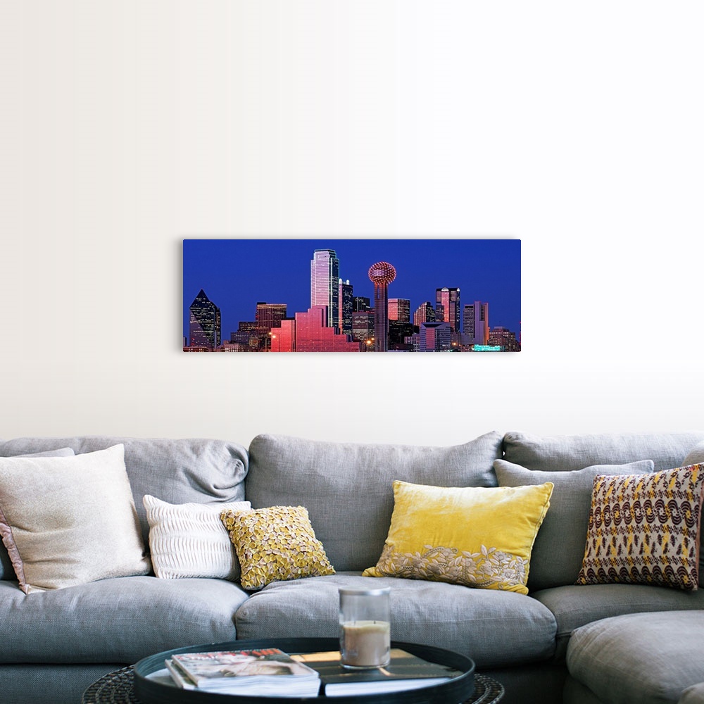 A farmhouse room featuring This wall art is a panoramic photograph of the city skyline glowing and glimmering in the night sky.