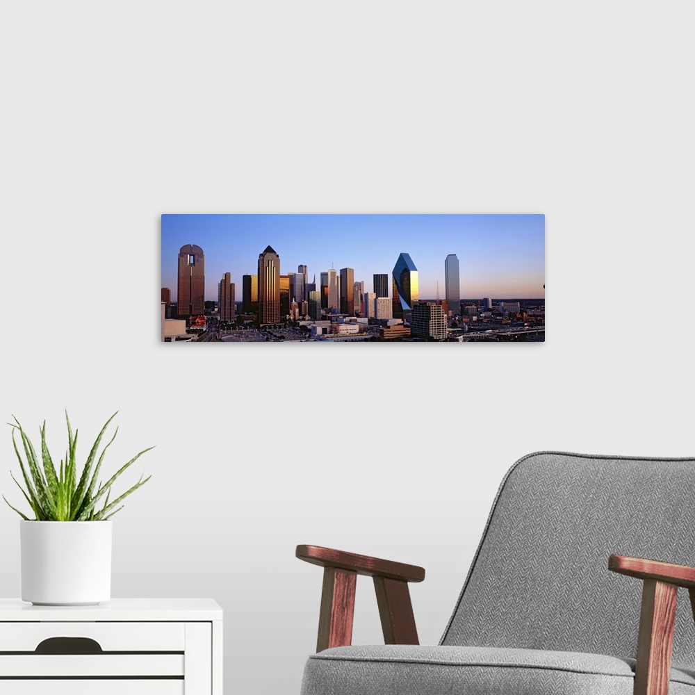 A modern room featuring Oversized, panoramic photograph of the Dallas skyline at sunrise.