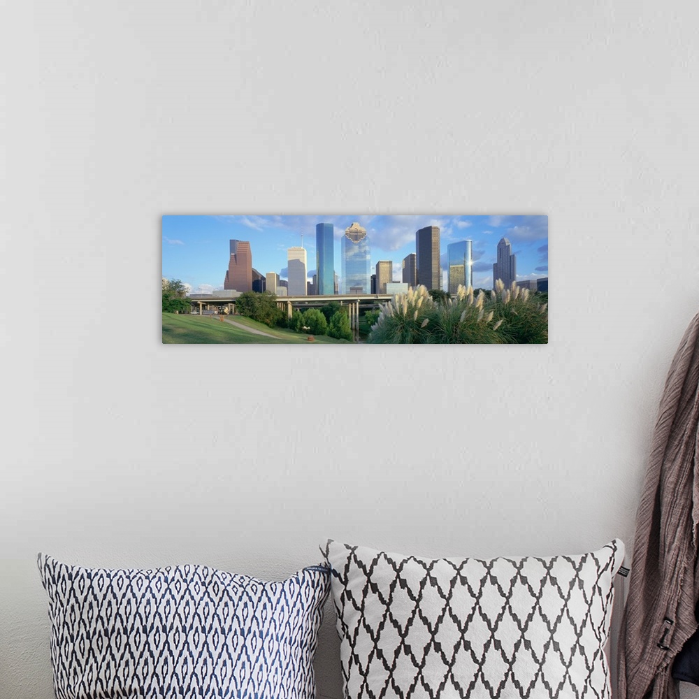 A bohemian room featuring Panoramic photograph of skyline with buildings and skyscrapers under a cloudy sky.