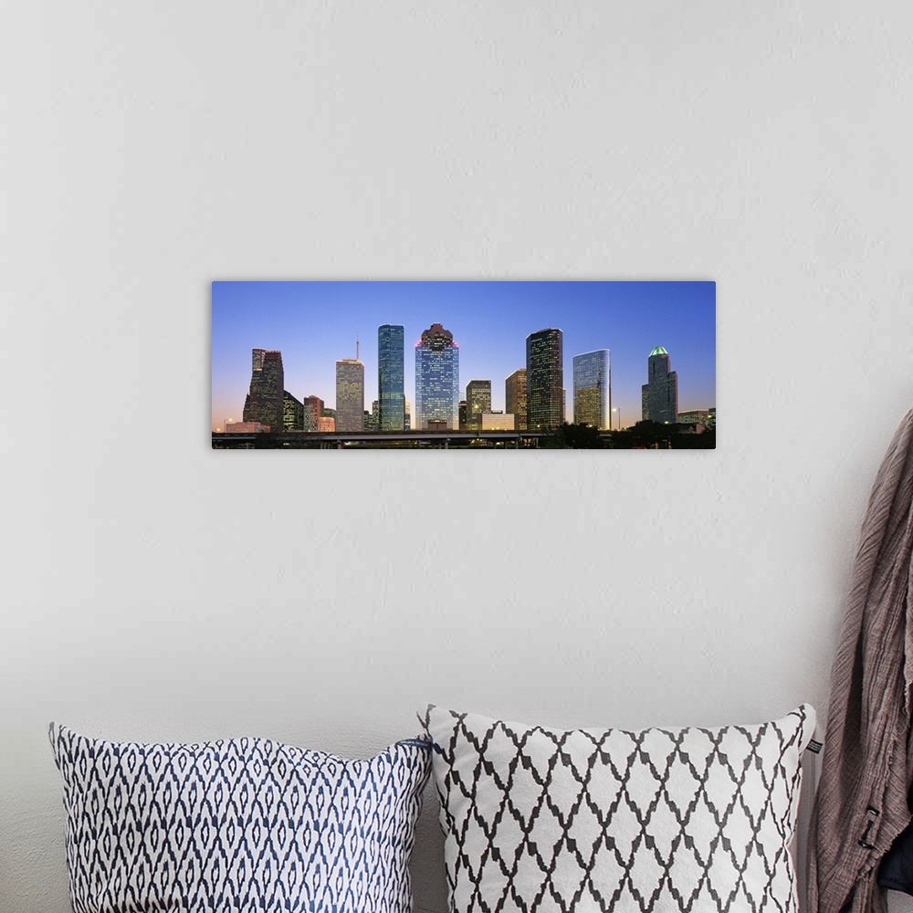 A bohemian room featuring Panoramic photo of a cityscape at dusk with the lights on in some of the buildings.