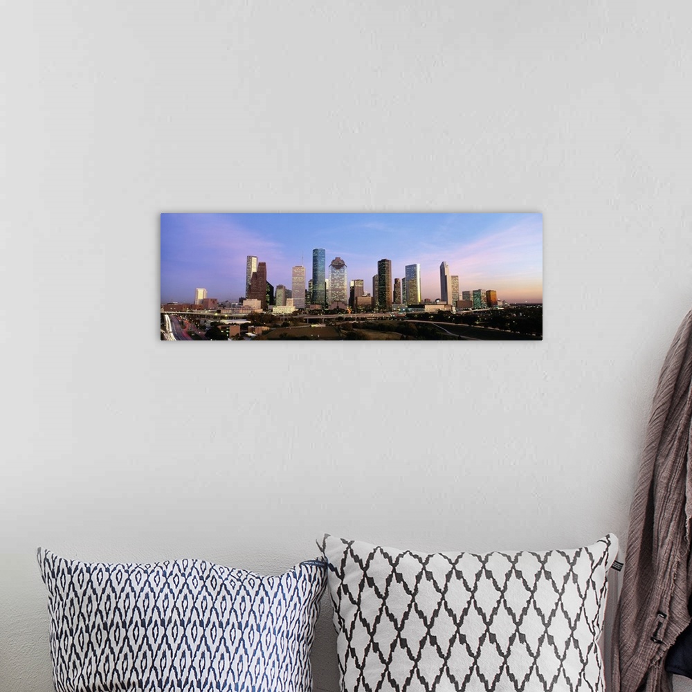 A bohemian room featuring Houston skyline buildings at twilight.