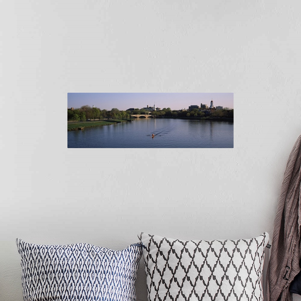 A bohemian room featuring Panoramic photograph of rower in lake lined by trees with bridge in the distance under a clear sky.