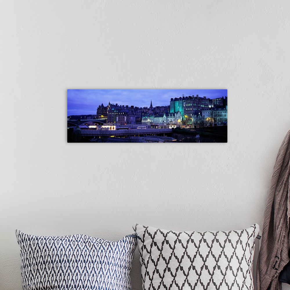 A bohemian room featuring Panoramic picture taken of an illuminated Scotland town.