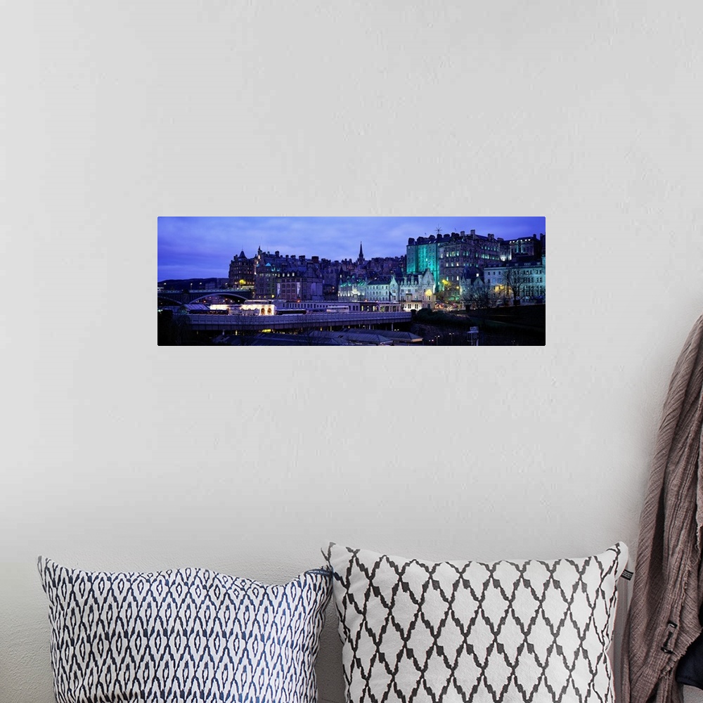 A bohemian room featuring Panoramic picture taken of an illuminated Scotland town.