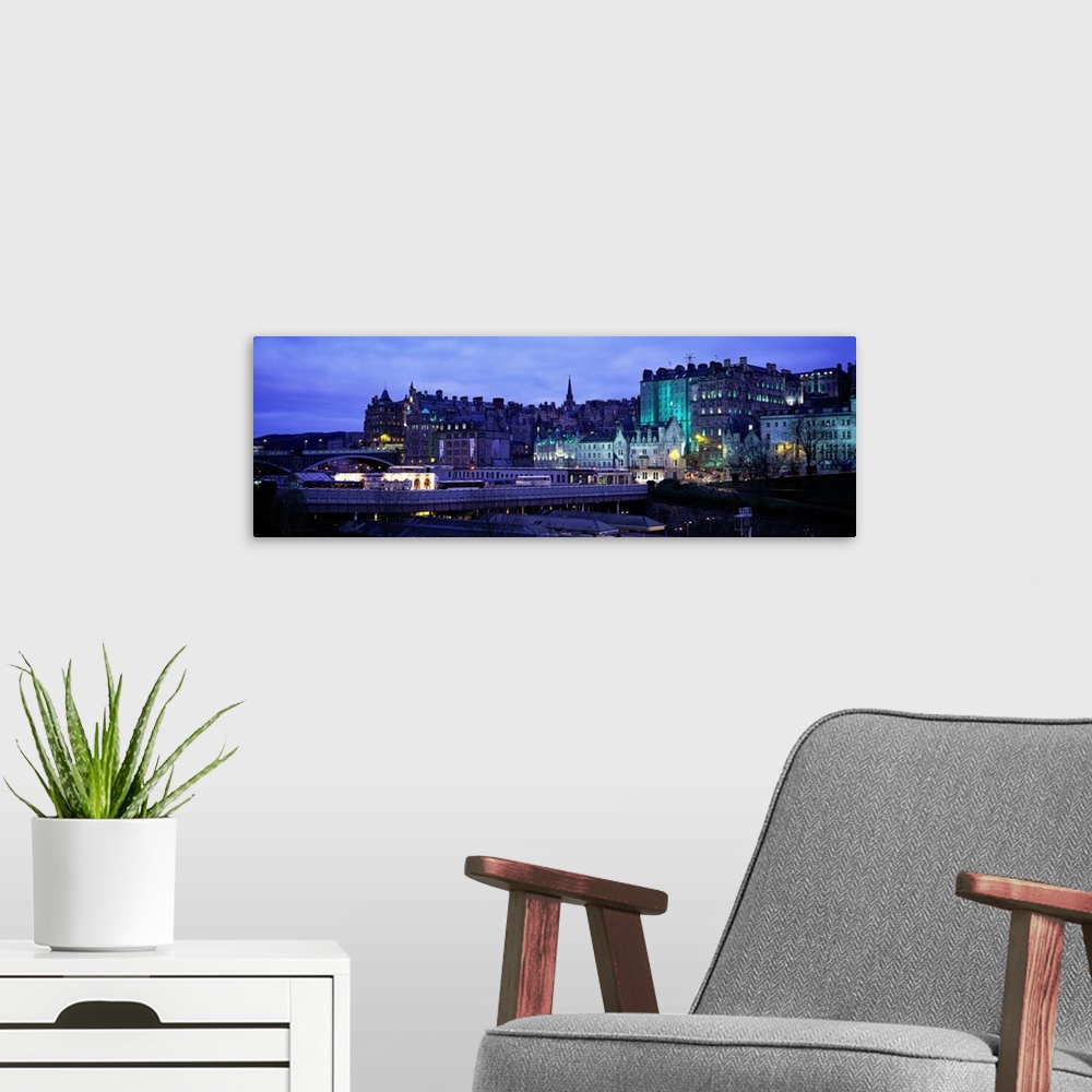A modern room featuring Panoramic picture taken of an illuminated Scotland town.