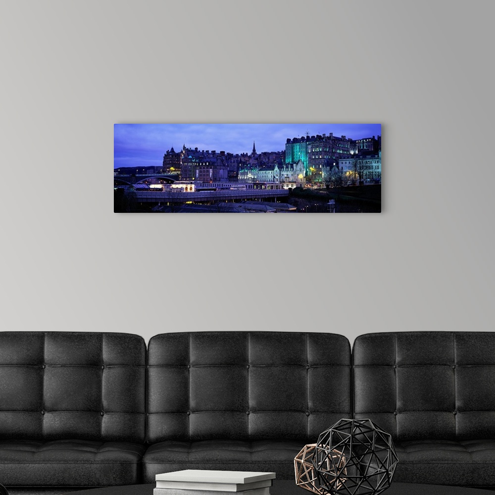A modern room featuring Panoramic picture taken of an illuminated Scotland town.