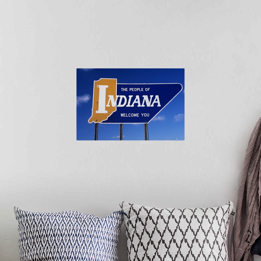 A bohemian room featuring The People of Indiana Welcome You State Sign