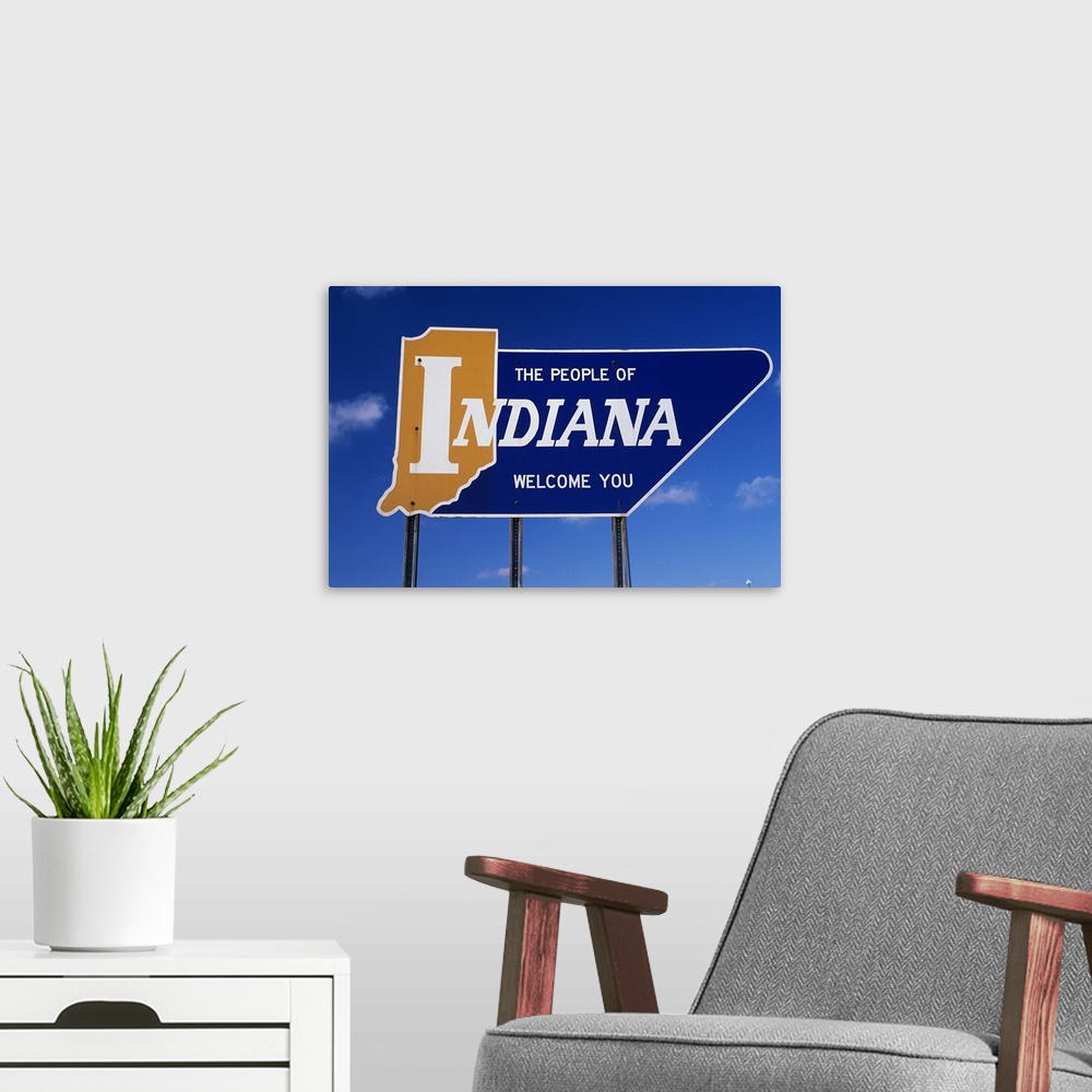 A modern room featuring The People of Indiana Welcome You State Sign