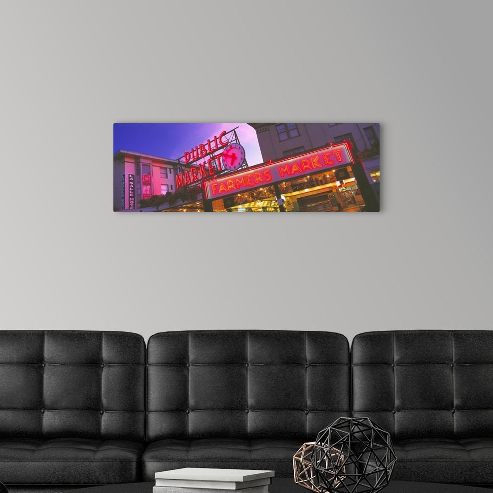 A modern room featuring Big, landscape photograph, taken at and angle, of the neon Public Market sign in Seattle, Washing...