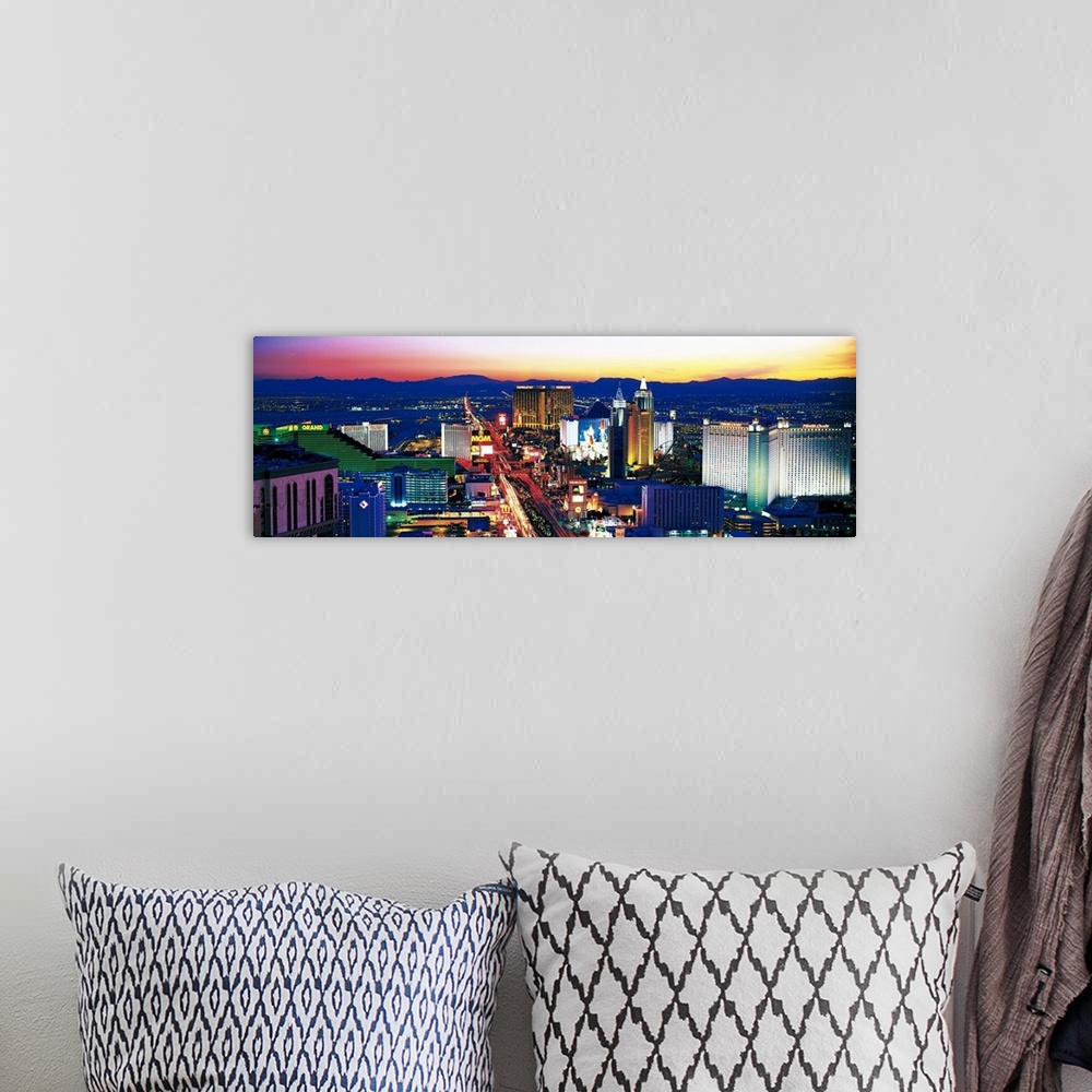 A bohemian room featuring Panoramic photograph of city at sunset with mountains in the distance.  The buildings are brightl...