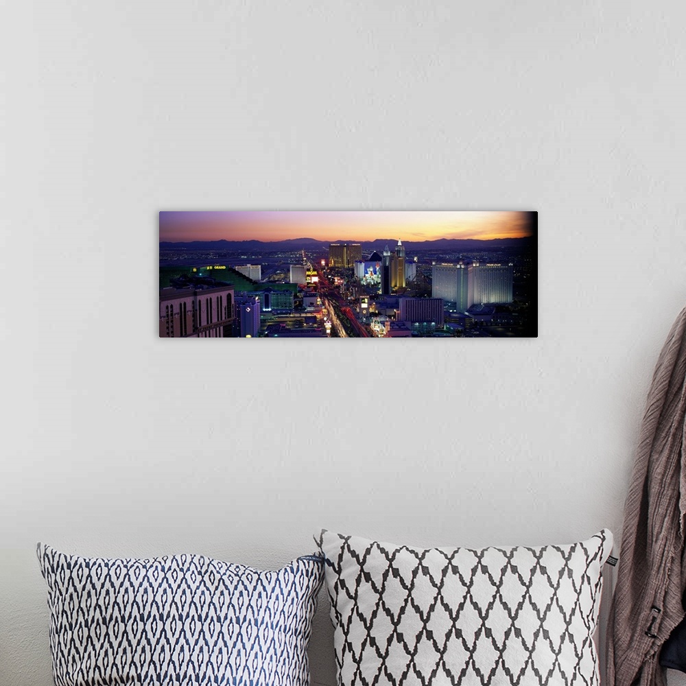 A bohemian room featuring Panoramic photograph of ""Sin City"" skyline at sunset with buildings lit up and mountains in the...