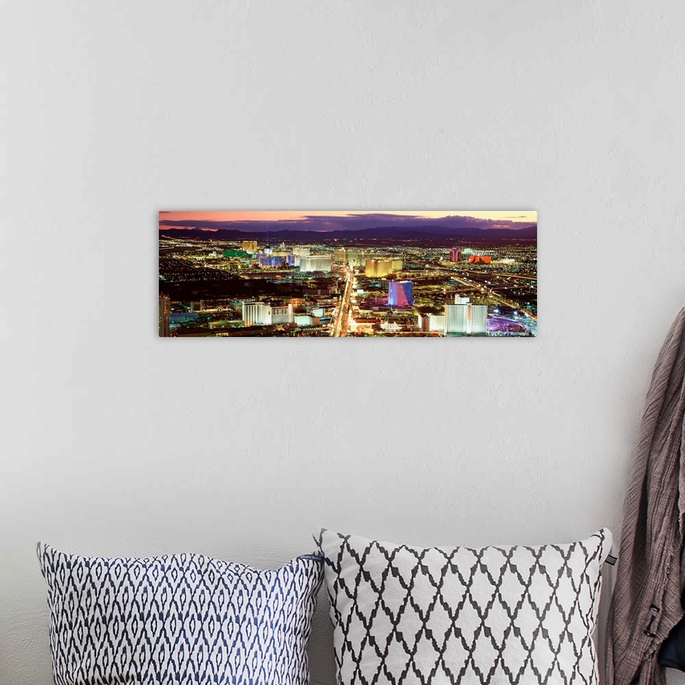 A bohemian room featuring This wall art is a panoramic photograph taken from high in the air of the Sin cityos night lights...