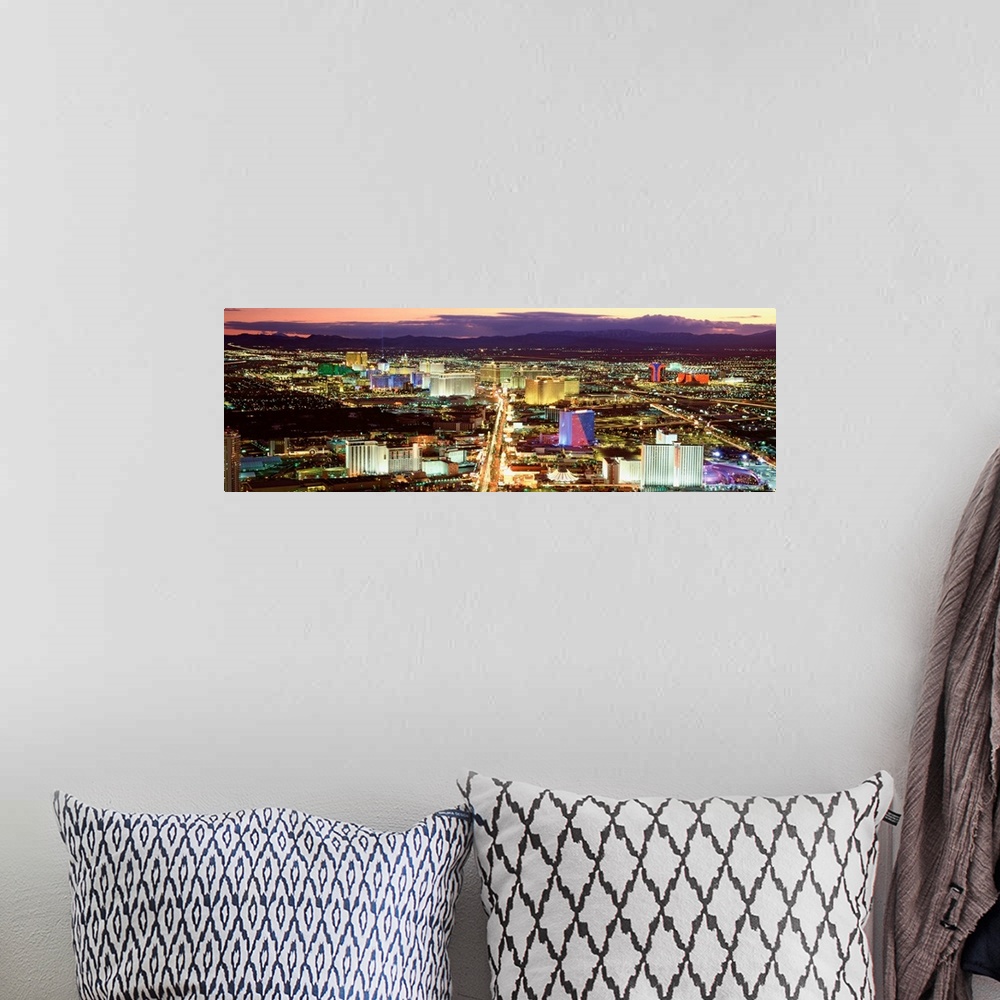 A bohemian room featuring This wall art is a panoramic photograph taken from high in the air of the Sin cityos night lights...
