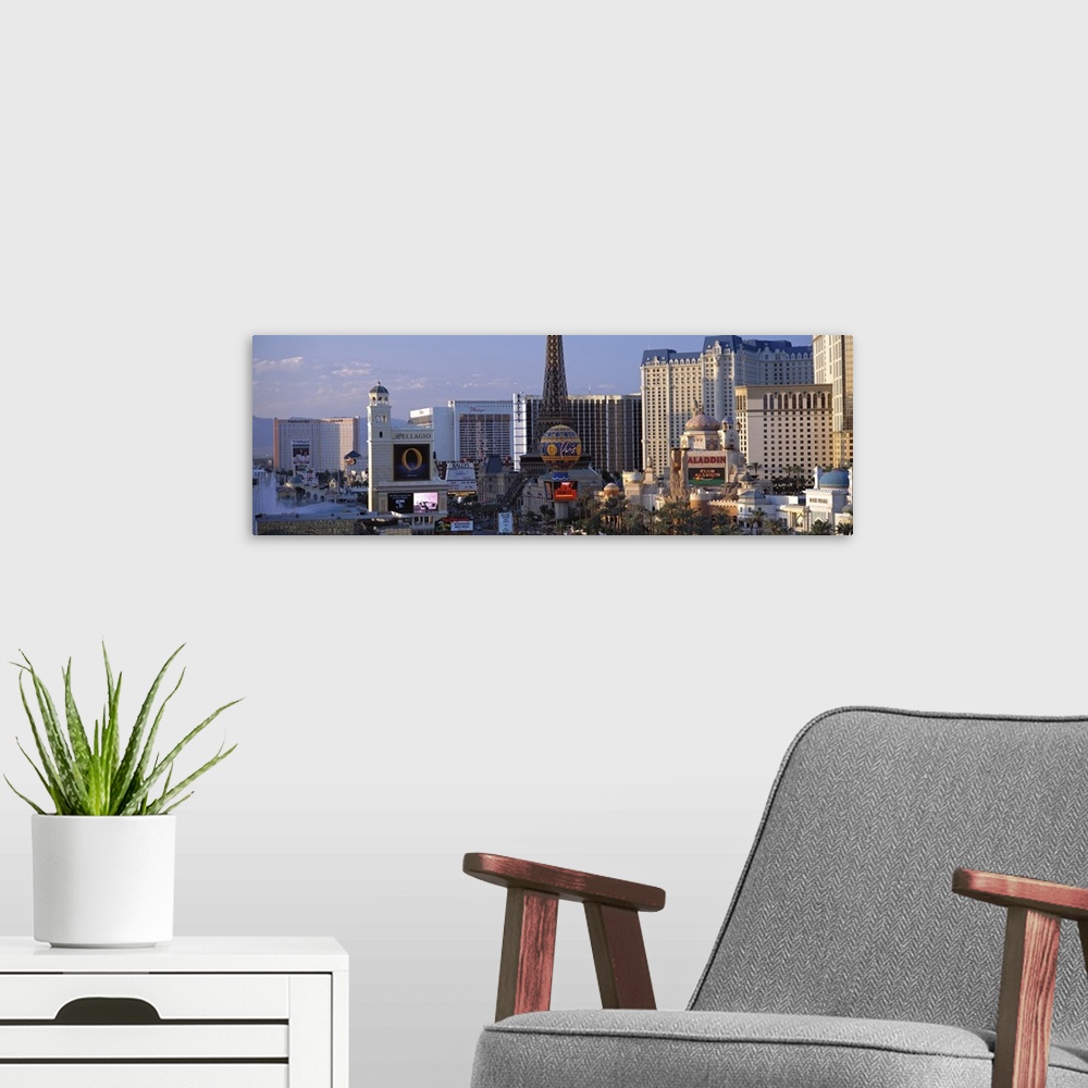 A modern room featuring Panoramic photograph on a large canvas of the Las Vegas strip during the day, including the Bella...