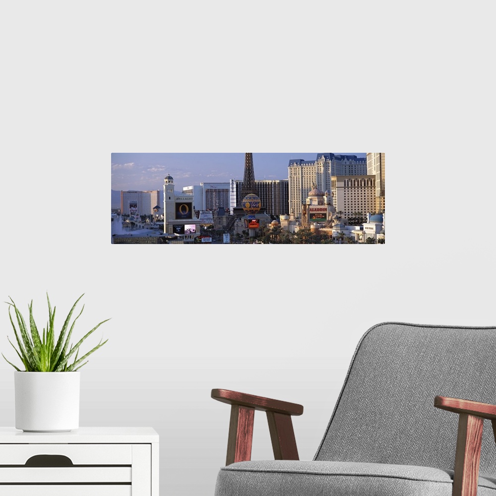 A modern room featuring Panoramic photograph on a large canvas of the Las Vegas strip during the day, including the Bella...