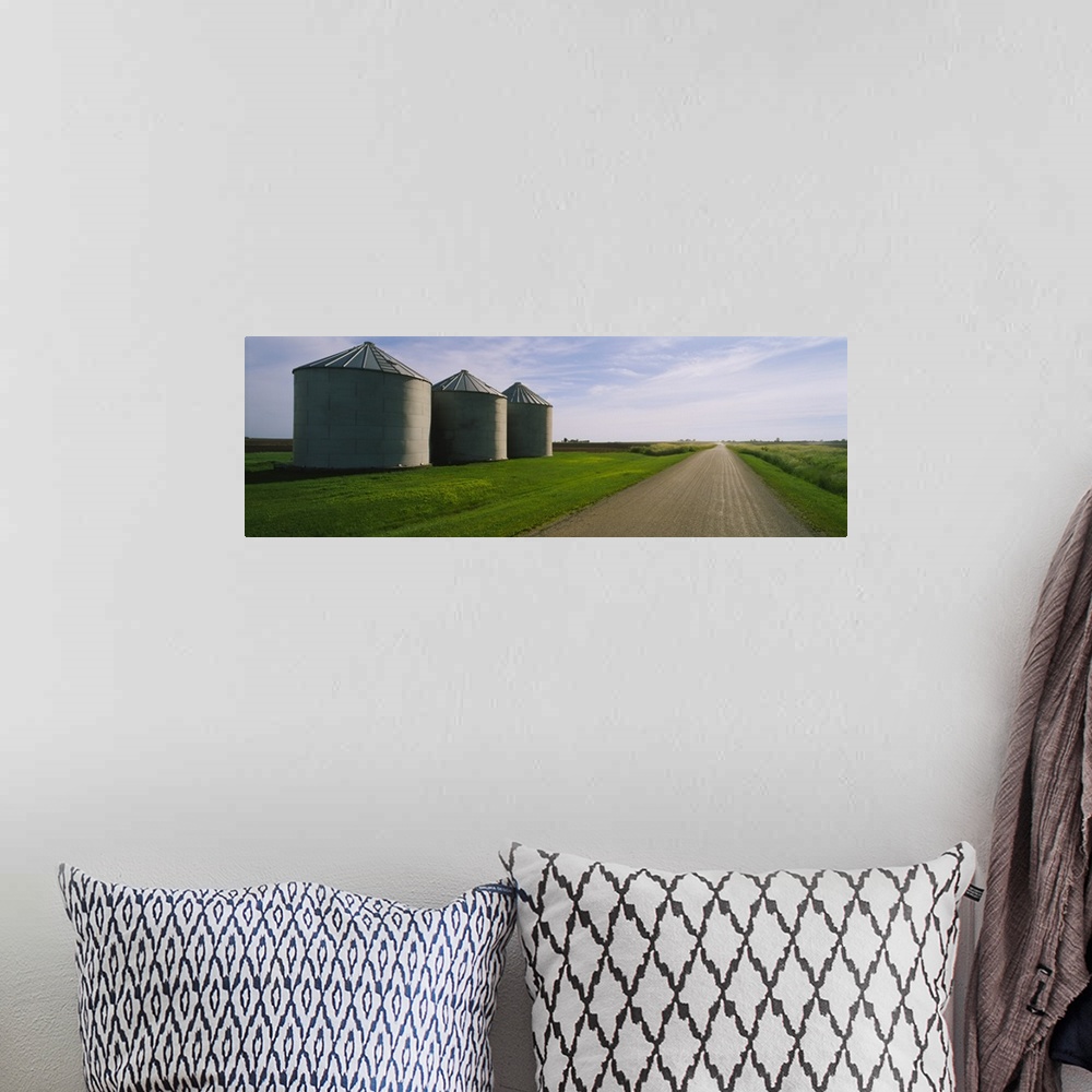 A bohemian room featuring Three silos in a field