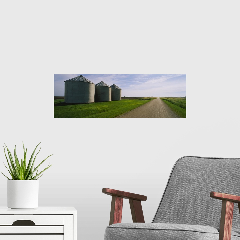 A modern room featuring Three silos in a field