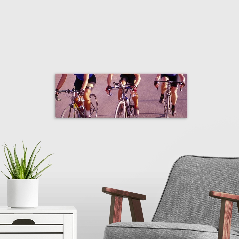 A modern room featuring Three women cycling