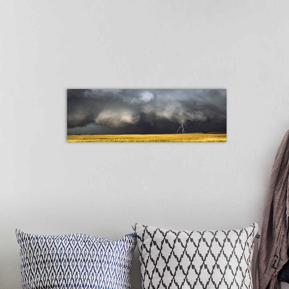 A bohemian room featuring Panoramic photograph of storm clouds with lightning striking the ground over a meadow of tall grass.
