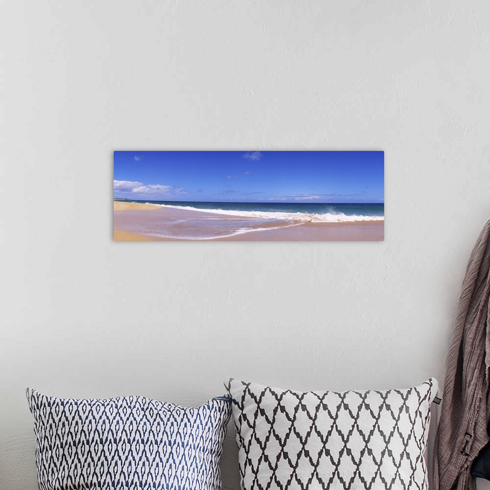 A bohemian room featuring This is a landscape panoramic photograph of a flat sandy shoreline and a calm sea with few clouds...