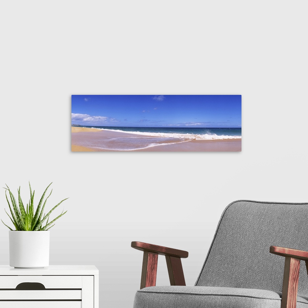 A modern room featuring This is a landscape panoramic photograph of a flat sandy shoreline and a calm sea with few clouds...