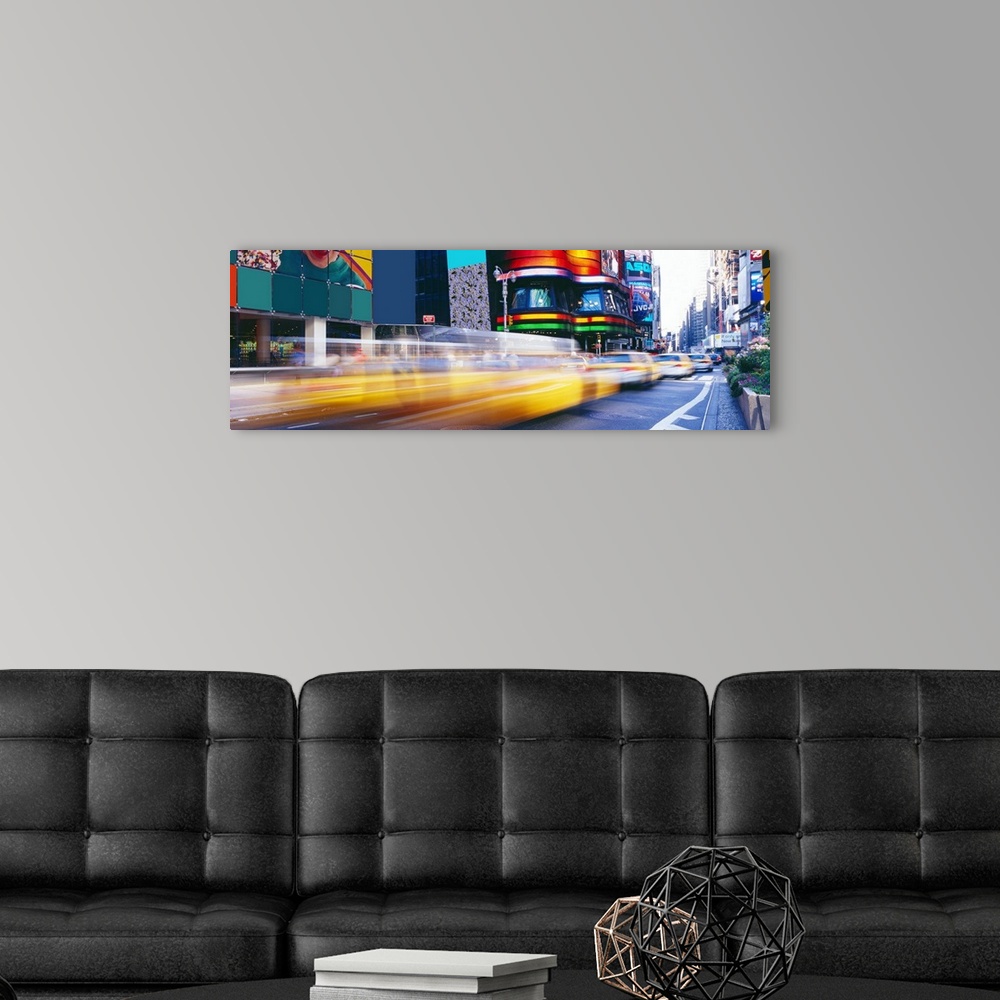 A modern room featuring Panorama of New York City's Times Square and fast paced yellow cabs.
