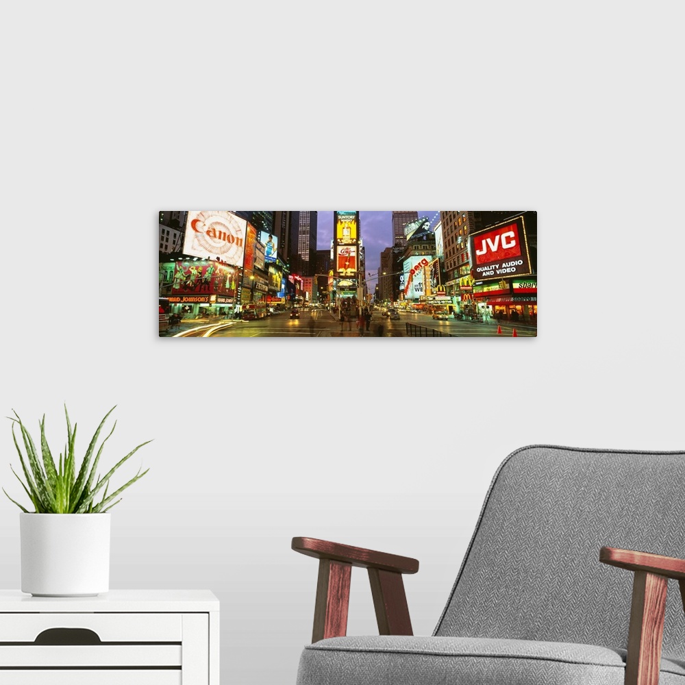 A modern room featuring Wide angle photograph of Times Square in New York City, lit at night, with billboards including C...