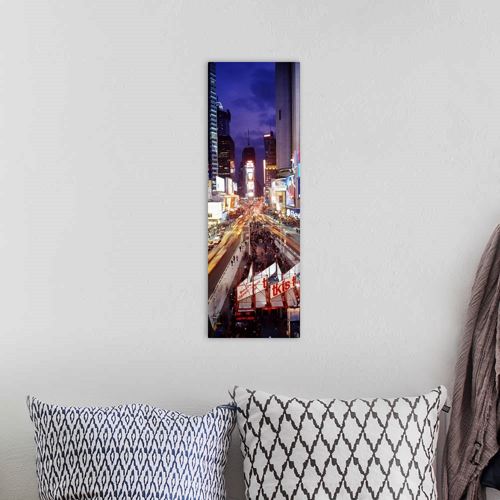 A bohemian room featuring Vertical panoramic of a busy Times Square at night with traffic lined streets and tourists in lin...