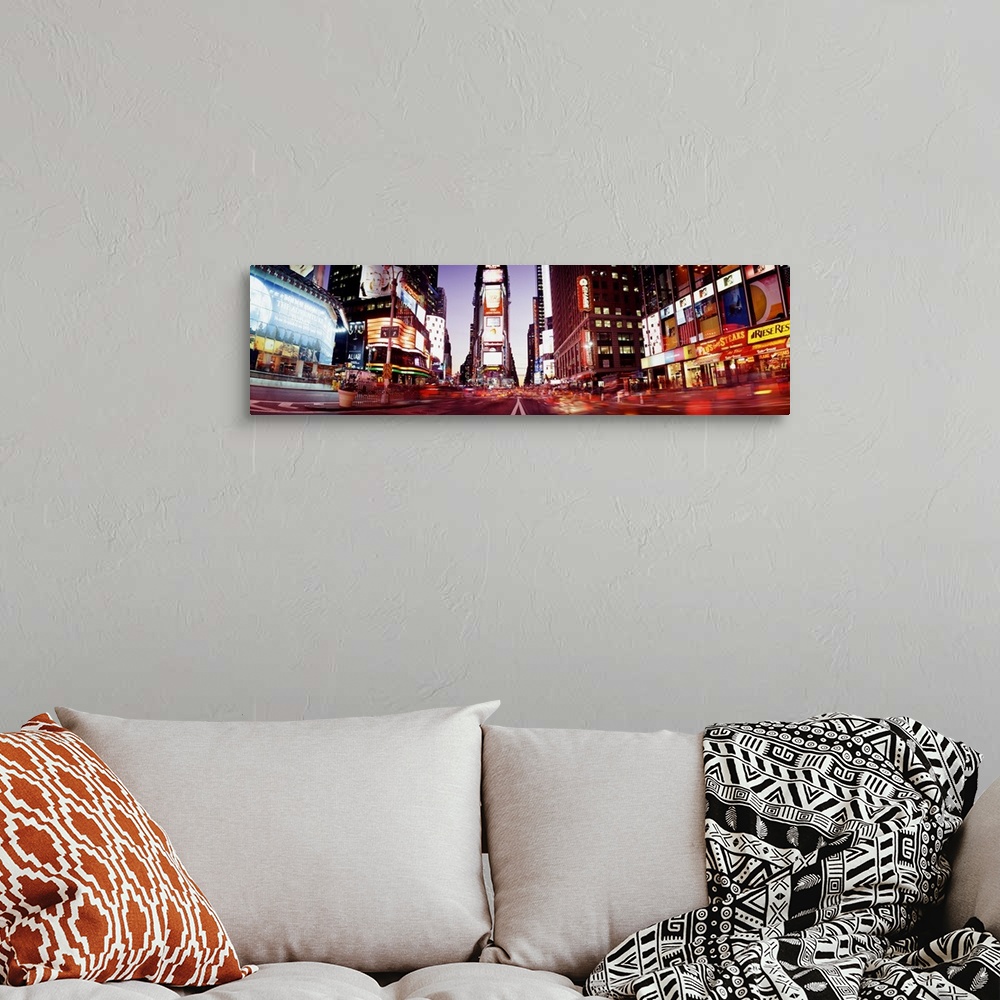 A bohemian room featuring Part of Times Square is photographed in panoramic view while it's illuminated under the dusk sky.