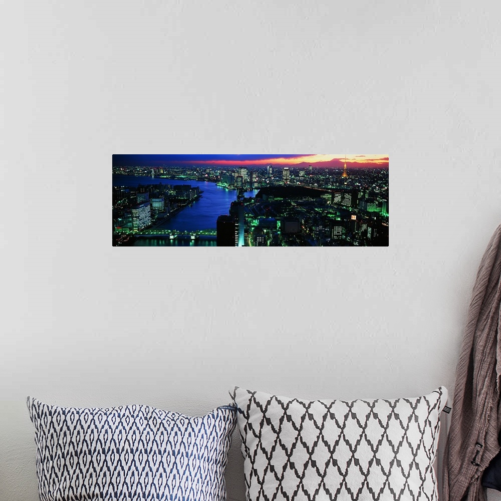 A bohemian room featuring Panoramic photo on canvas of a lit up downtown cityscape with water flowing through it.