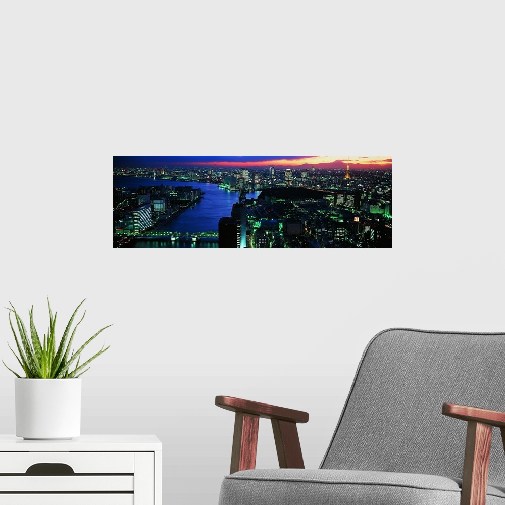 A modern room featuring Panoramic photo on canvas of a lit up downtown cityscape with water flowing through it.