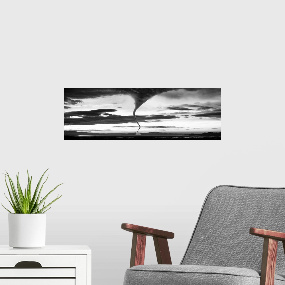 A modern room featuring Panoramic photograph of funnel cloud reaching down to earth surrounded by a dark, cloudy, stormy ...