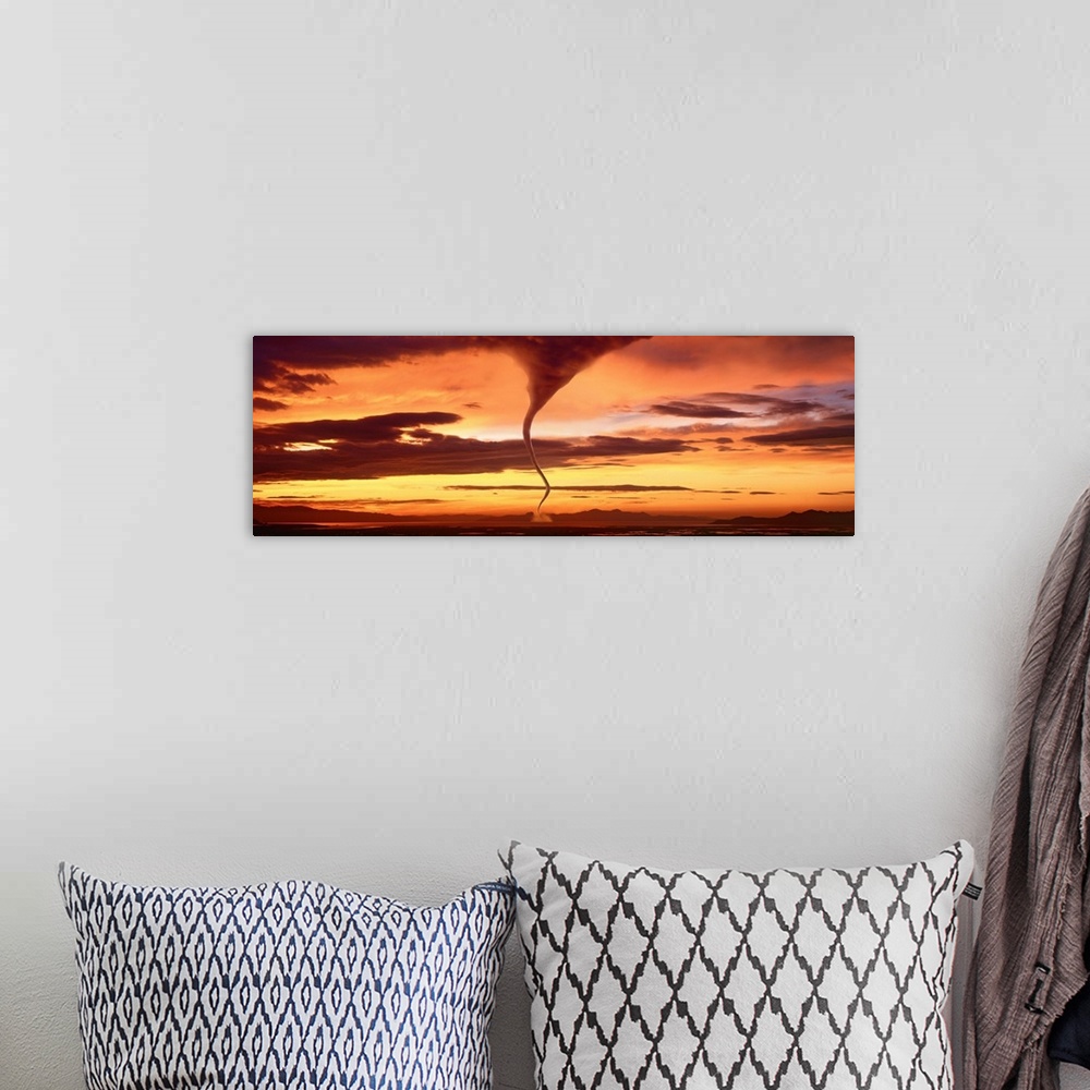 A bohemian room featuring A large panoramic shot of a tornado touching down with a sunset sky stretching across the entire ...