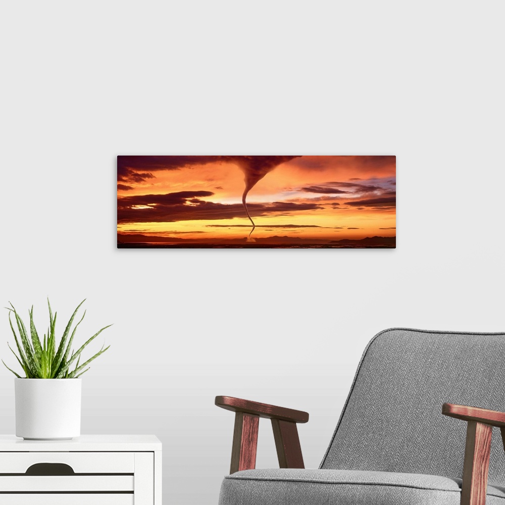 A modern room featuring A large panoramic shot of a tornado touching down with a sunset sky stretching across the entire ...